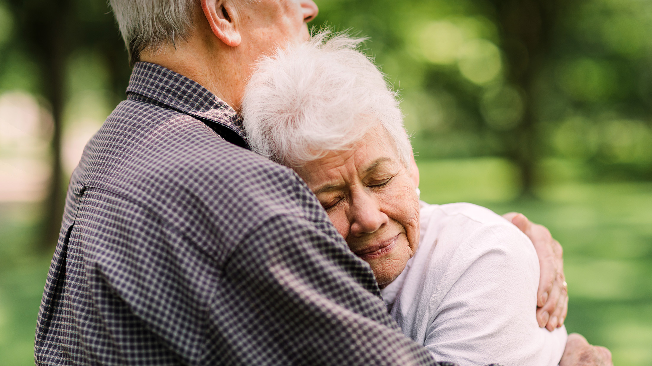 elderly woman hugging her husband