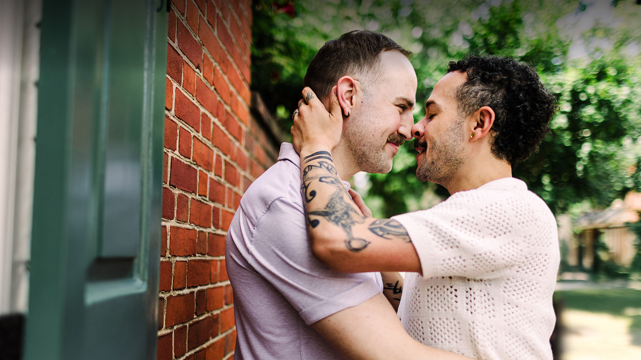 Engagement photo showing two men touching noses