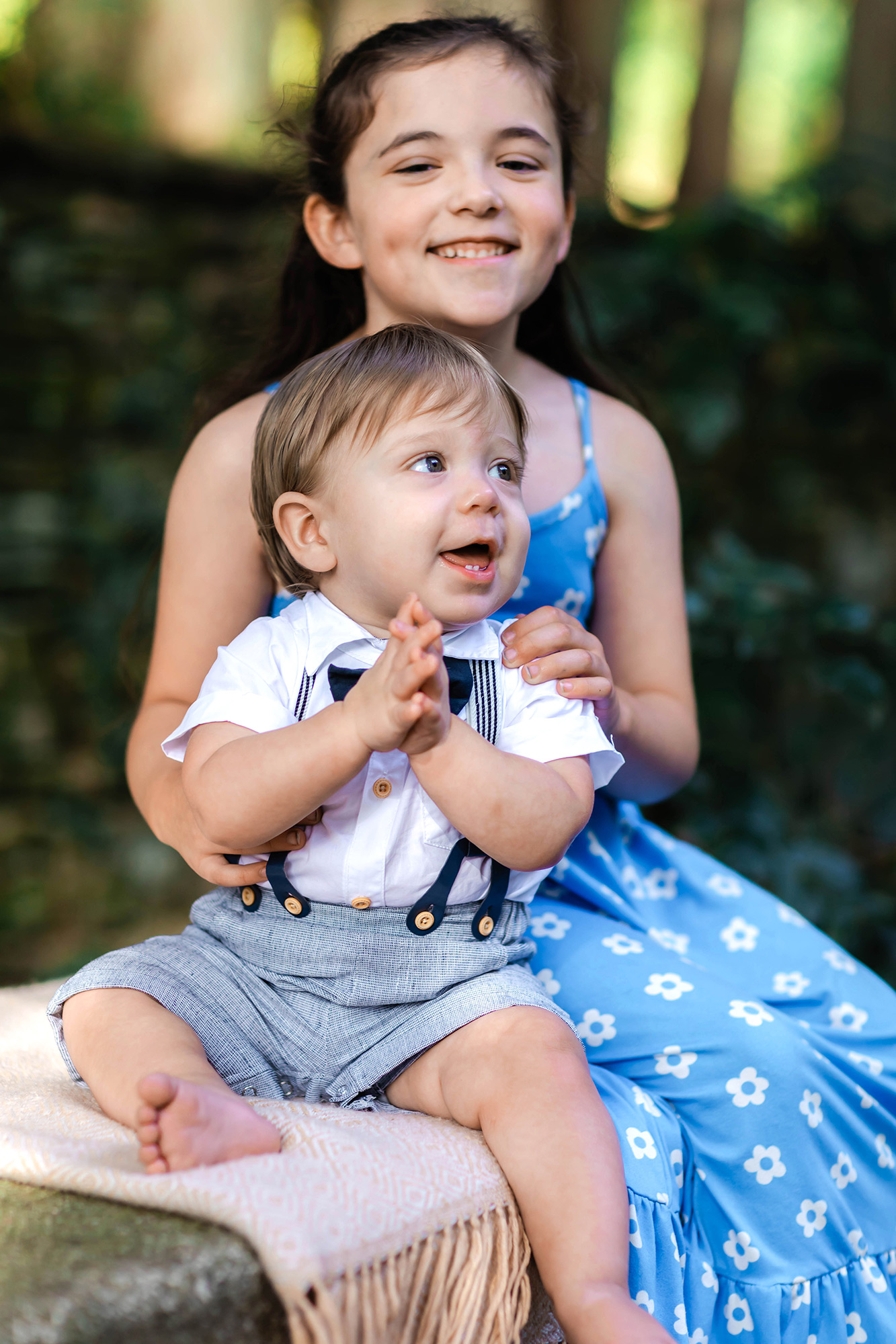 Brother and sister sitting on bench