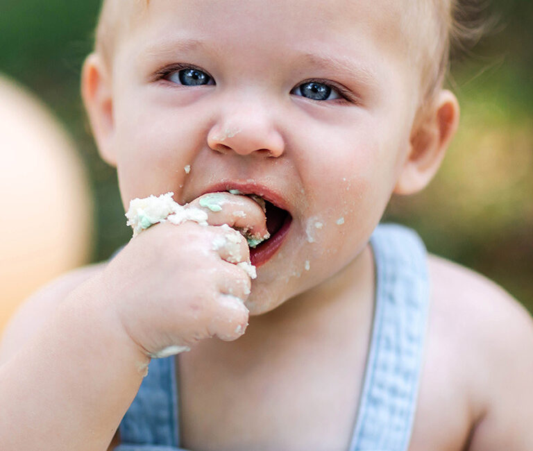Baby eating cake for a cake smash photoshoot