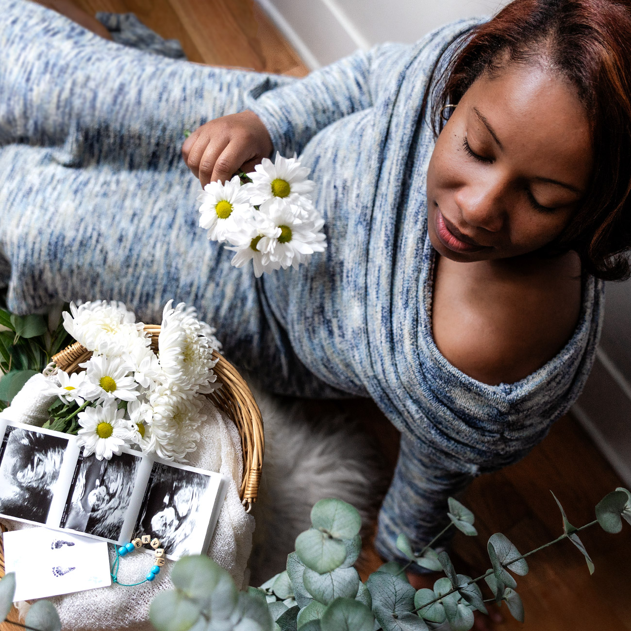Portrait of mother next to her keepsakes from a pregnancy loss