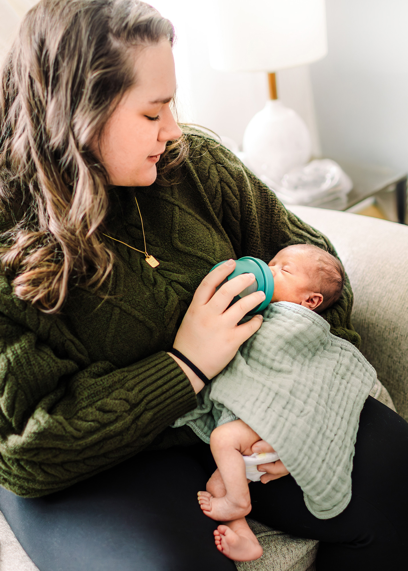 Mom feeding newborn with a bottle