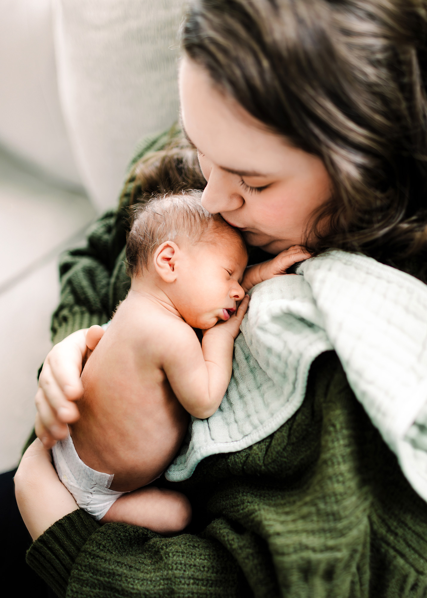 Mom burping a sleeping newborn on her chest