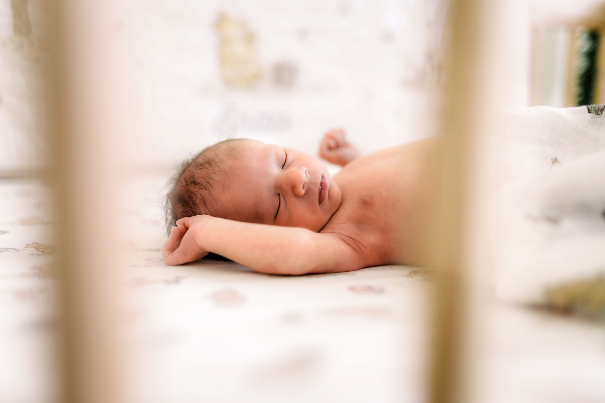 Newborn in Winny the Pooh crib