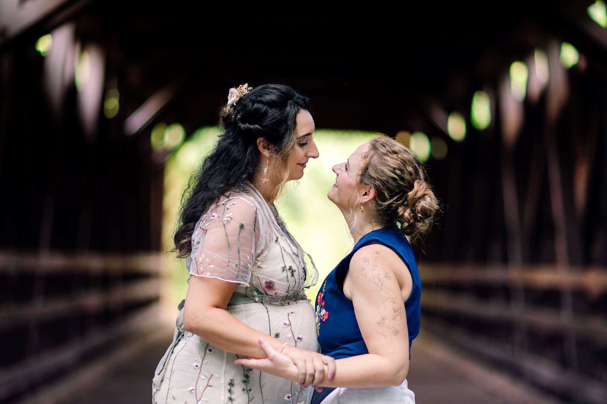 Wedding portrait of two brides at the Thomas Mill Historic Bridge