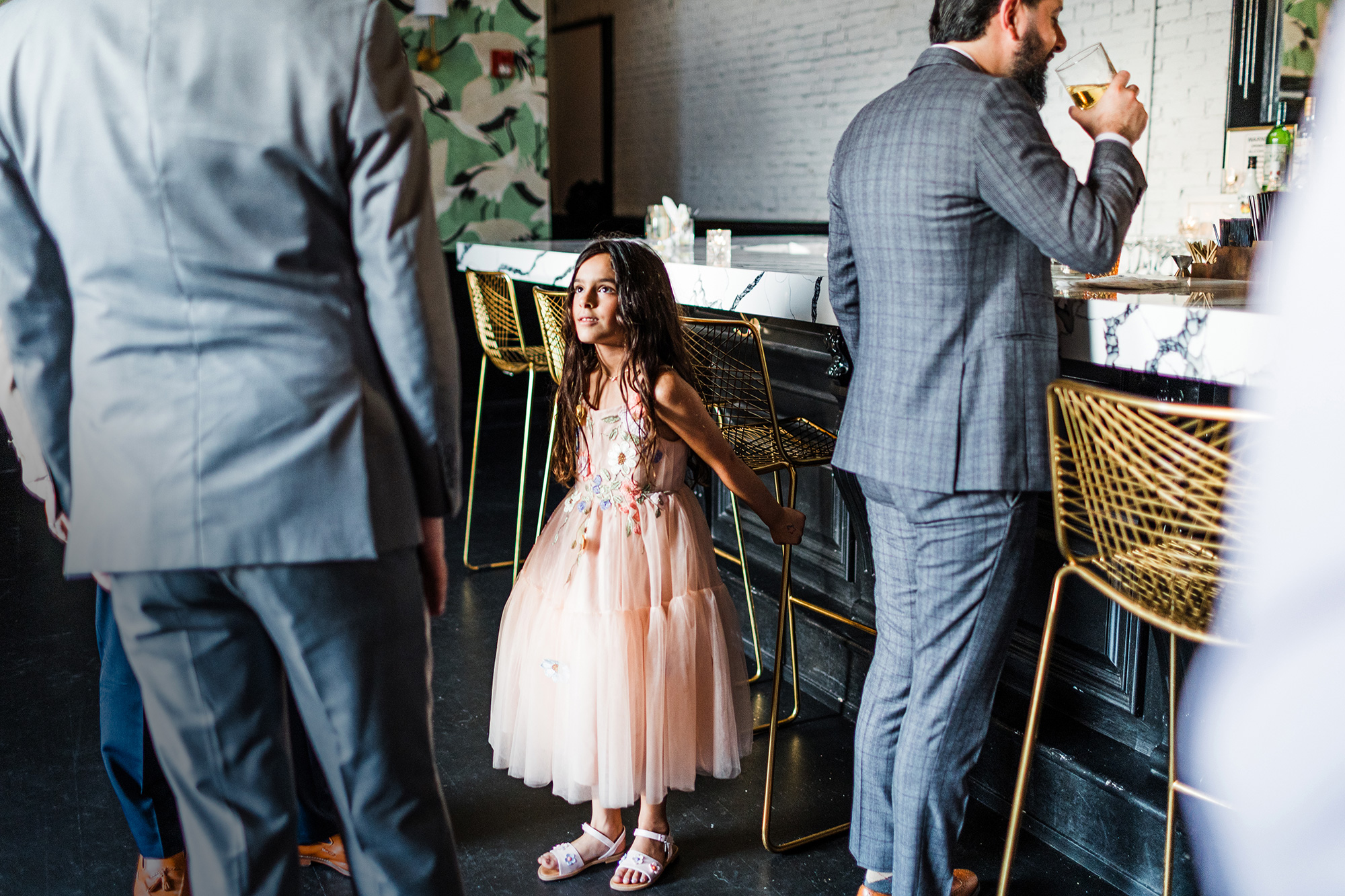 Flower girl at the bar during a wedding reception